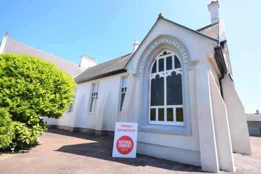 Whitehead Methodist Church with a National Churches Trust sign outside the front