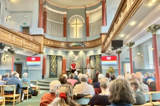 A member of National Churches Trust staff delivers a presentation inside a church