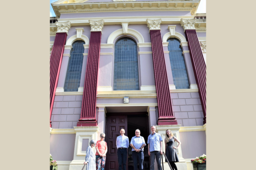 A group of people standing outside a church