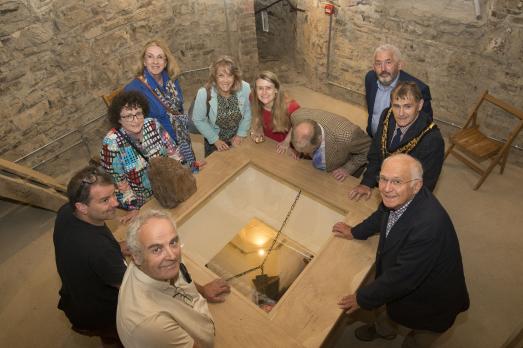 Taken on the 1st floor of the tower around a glazed viewing hatch with people looking down onto the ground floor of the church. 