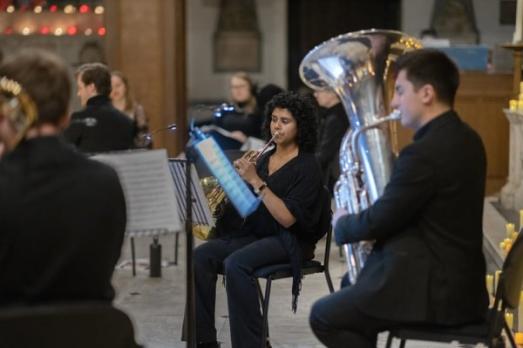 A brass section playing inside a church