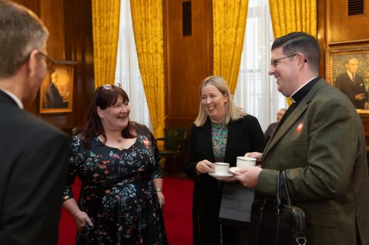 People laughing over a cup of tea