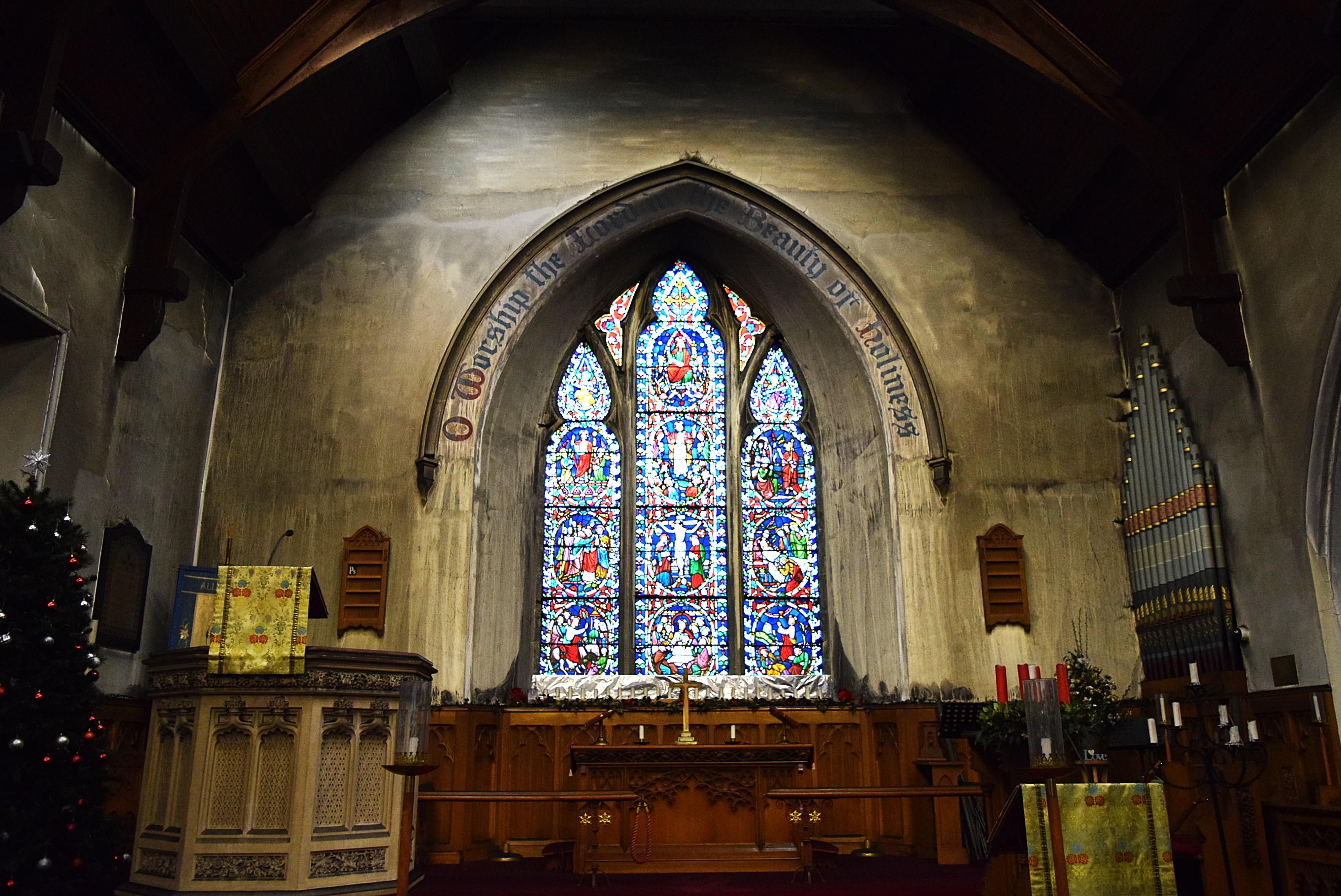 A stained glass window in a burned out church