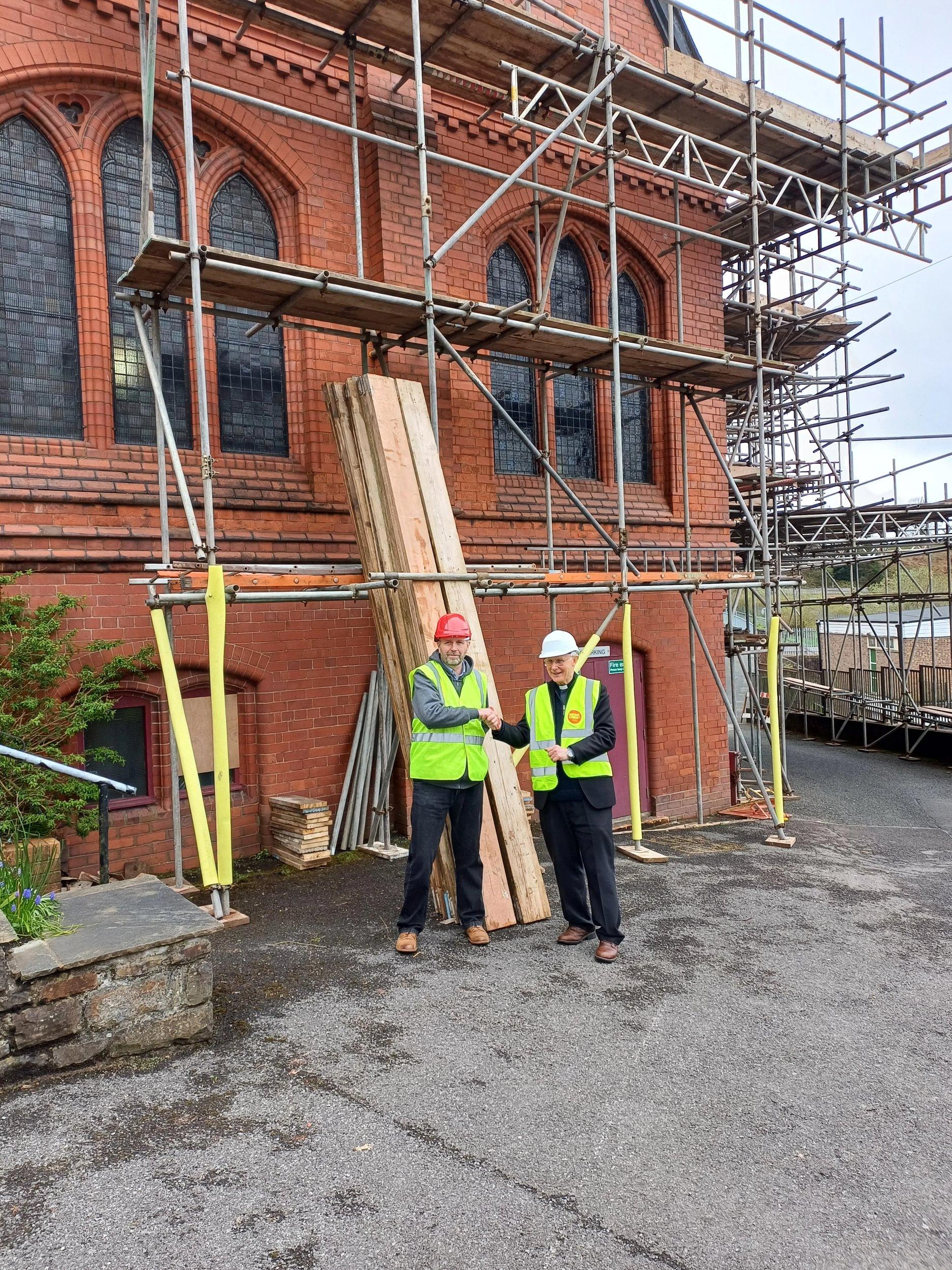 National Churches Trust staff with Canon Barry English outside St Illtyd Grade II Listed Church in Dowlais, Wales.