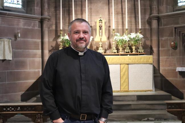 A vicar stands in front of the altar inside St Stephen on the Cliffs Church in Blackpool