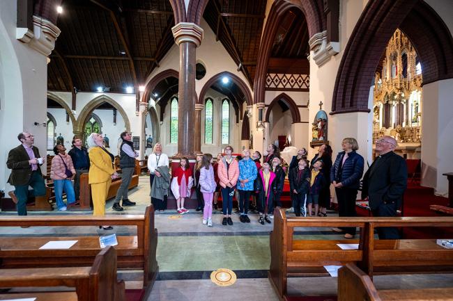 A group of people looking up at the ceiling inside a church