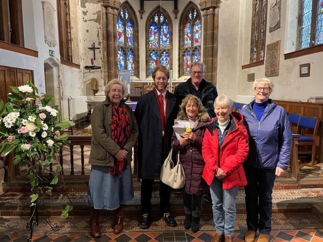 A group of six people stand inside Charnock Richard Christ Church