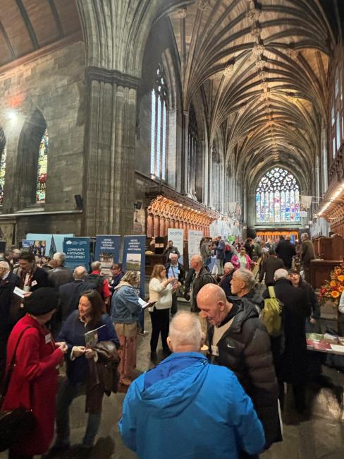 People standing around having conversations inside Paisley Abbey