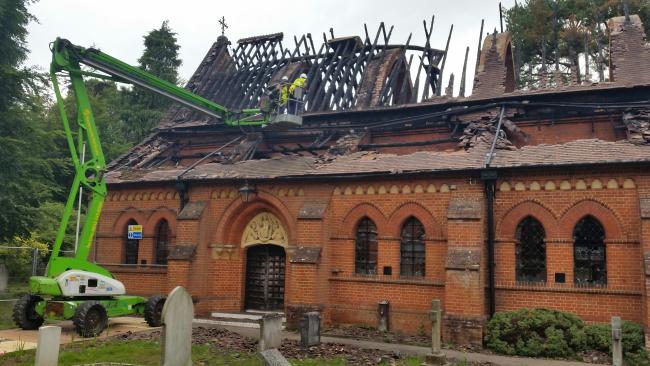 A cherry picker is used to carry out work on the damaged roof at Fleet All Saints